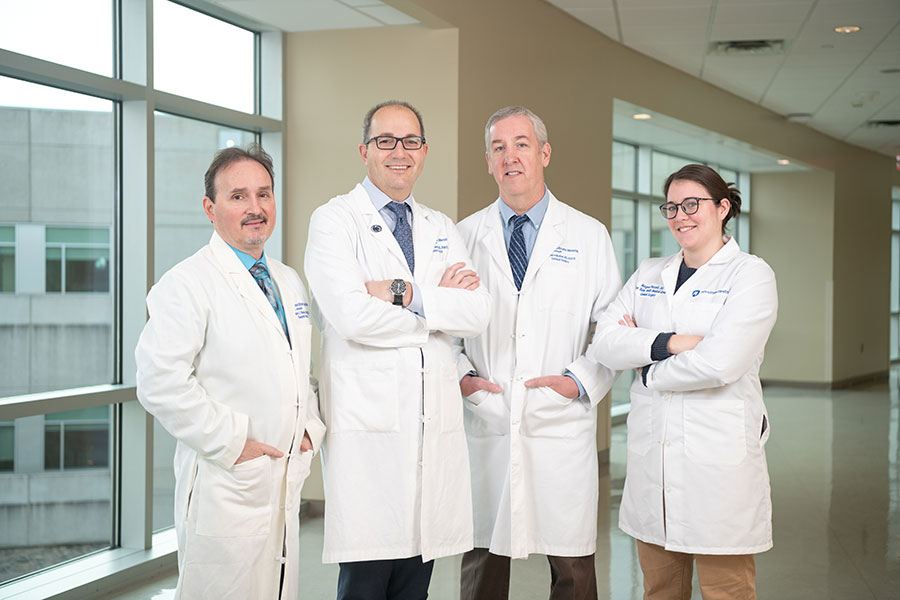 Group of doctors standing in a hall looking at the camera