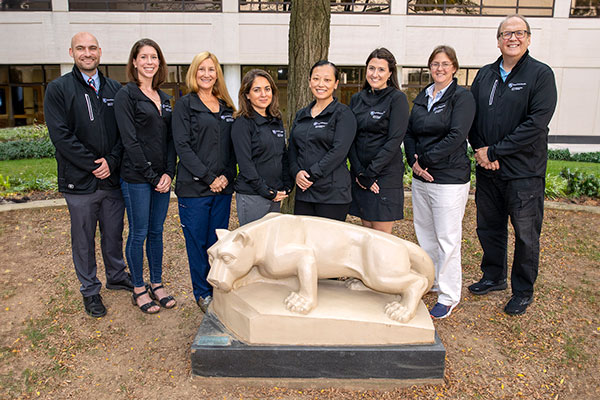 Adult Congenital Team group photo standing outside in front of the Nittany Lion statue