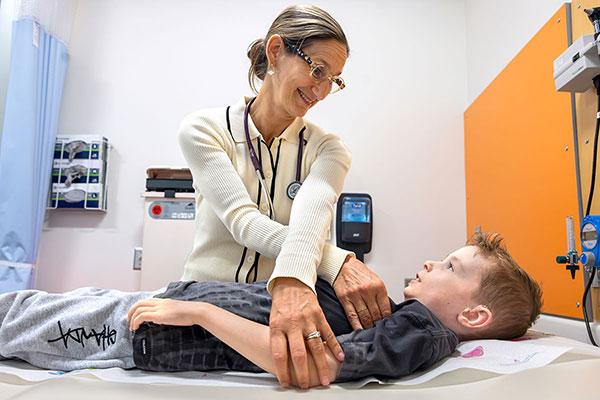 A doctor examines a pediatric patient