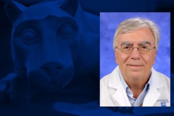 Photo shows a head shot of a man wearing glasses and a white doctor's coat overlaid on a blue graphic with a statue of a lion mascot