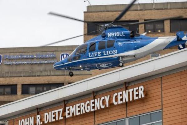 A helicopter lifts off from the roof of a building labeled "John R. Dietz Emergency Center."