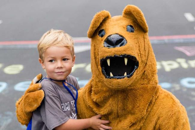 Young boy posing with the Penn State Nittany Lion